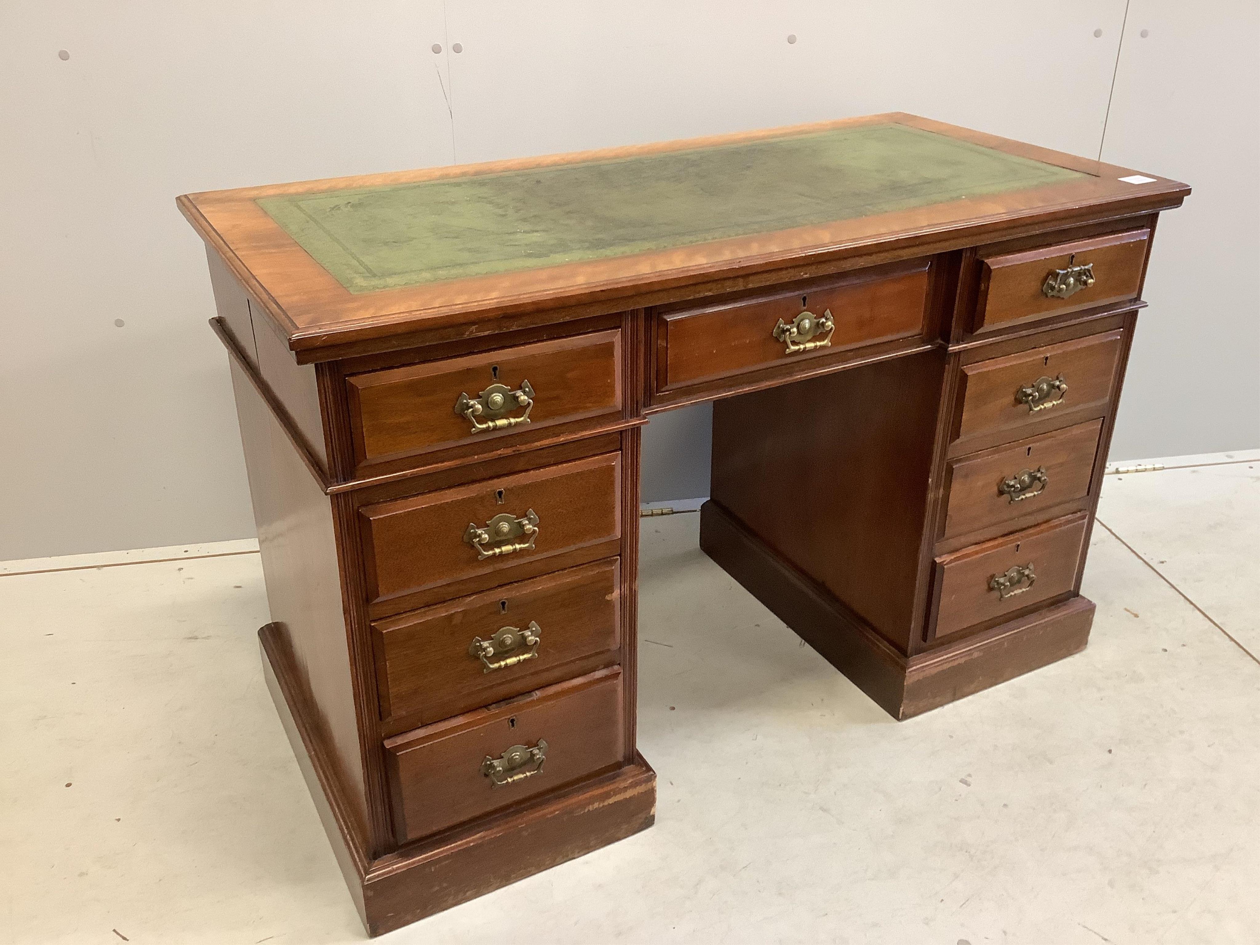 A late Victorian mahogany kneehole pedestal desk, fitted nine small drawers, width 121cm, depth 59cm, height 77cm. Condition - fair to good